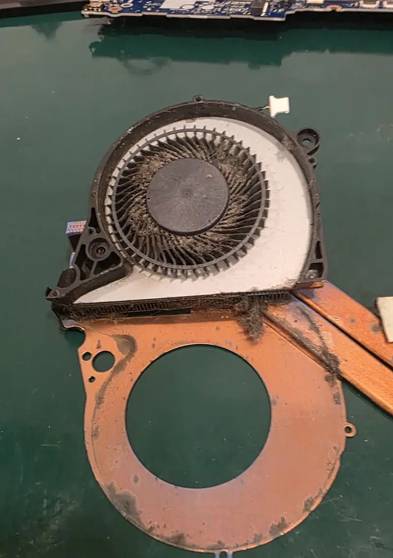 Segunda ventoinha do Dell G7 7588 aberta, com poeira acumulada nas pás e na entrada das aletas do dissipador